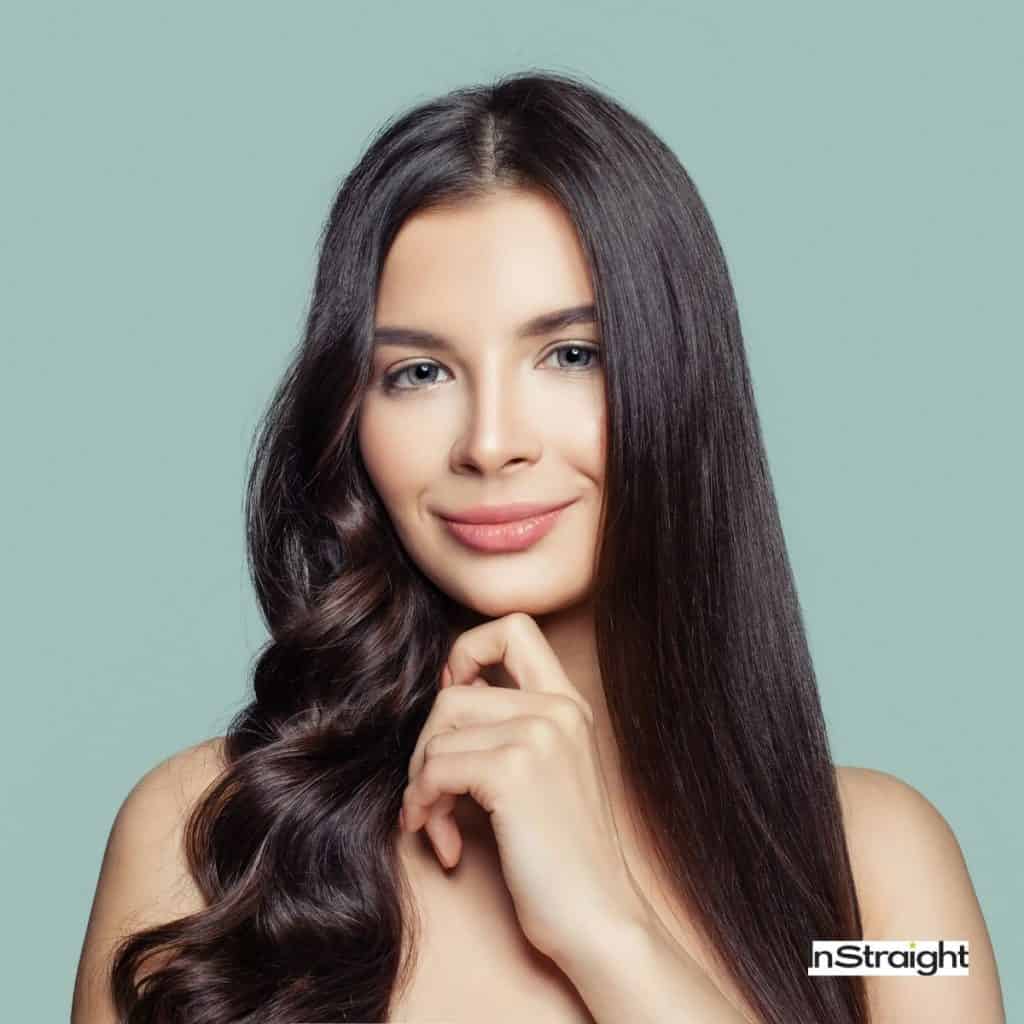 pretty girl showing how to make curly hair straight naturally